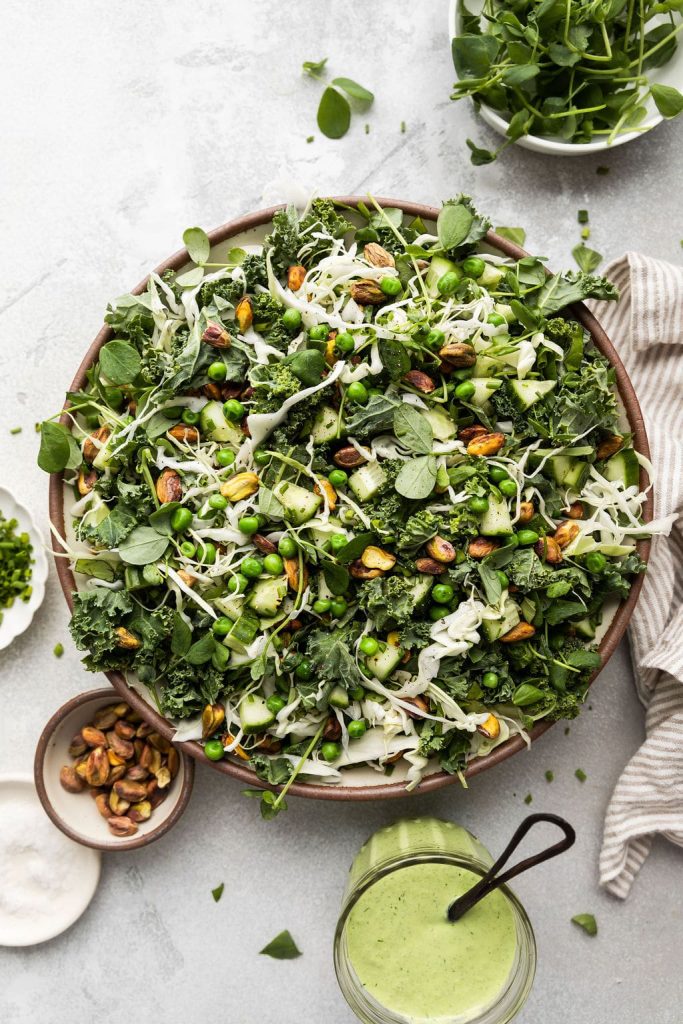 The viral vegan green goddess salad with creamy tahini-herb dressing, crunchy cabbage, and fresh toppings. The plant-based upgrade to 2026's most searched salad.